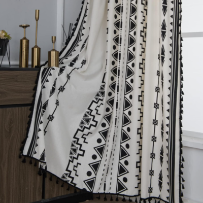Black and white geometric print cotton-linen semi-blackout curtain (single panel); Bohemian tassel style with grommet hanging; distinctive decor for bedrooms.